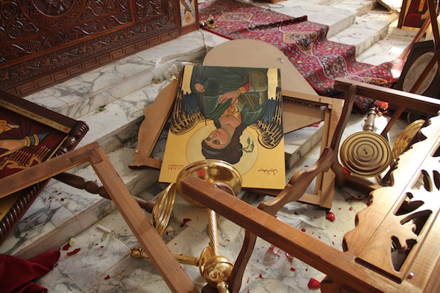 Icons and overturned furniture on the ground at the church of Saint Michael in the Syrian village of Qara